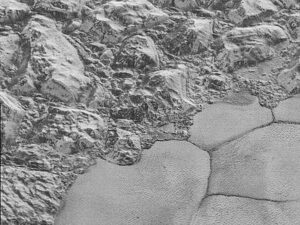 Rough icy dunes in the upper left and smooth terrain in lower right