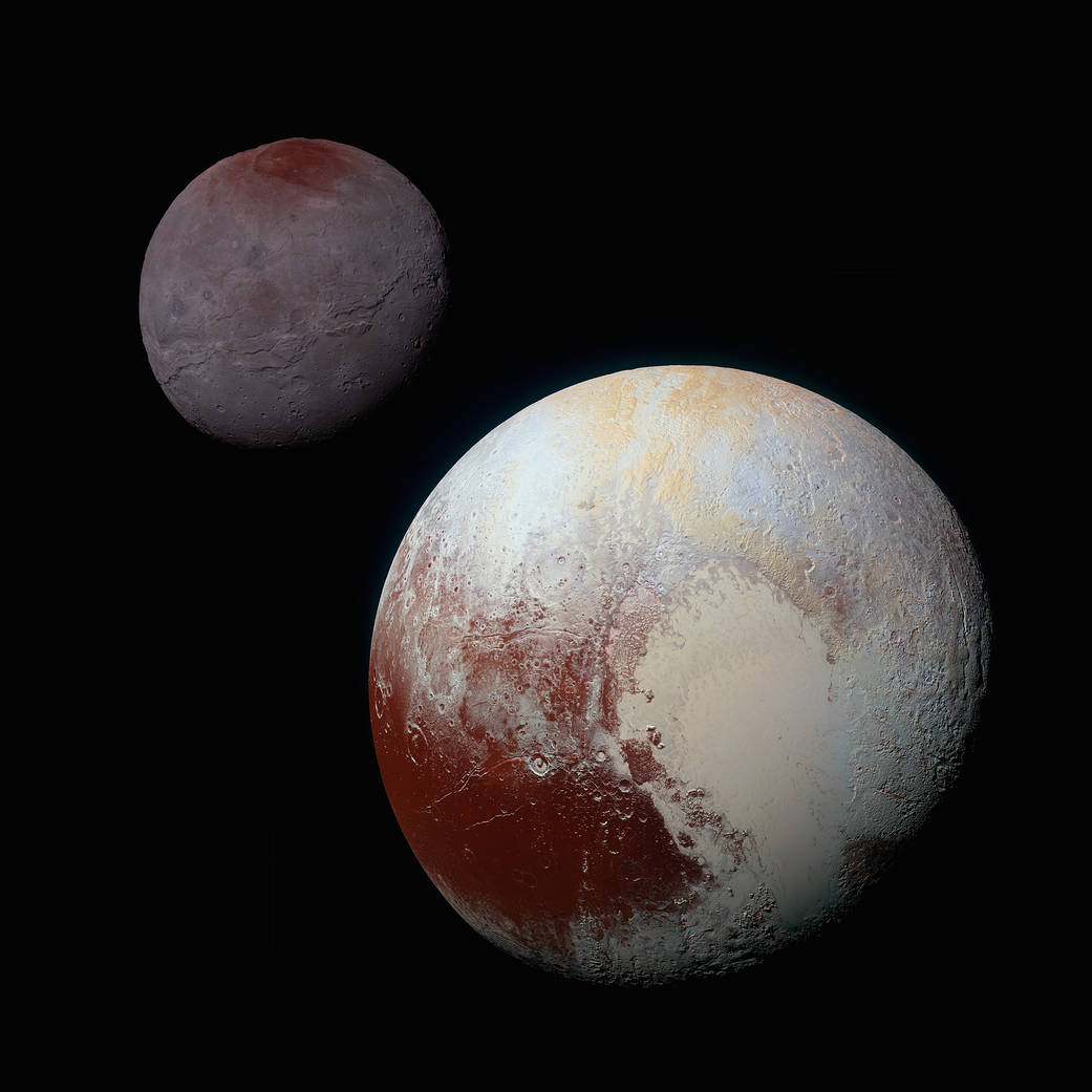 Pluto with heart feature in view in lower right and Charon in upper left corner behind it